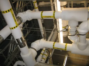 A complex assembly of PVC supply and return lines